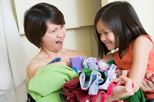 mother and child doing the laundry together