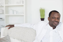 stylish black man on white couch